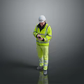 A Man In High Visibility Yellow Vest And White Hard Hat Using Smartphone