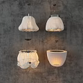 White Pleated Pendant Lights With Four Different Designs On Gray Wall Background