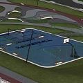 Scenic Park Landscape With Fenced Basketball Court Blue Surface Green Lawn And Curved Path