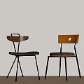 Two Modern Dining Chairs With Wooden Backrests Black Padded Seats And Metal Legs