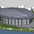 Modern Circular Glass Building Exterior With Scenic Waterfront And Green Grass