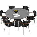 Round Dining Table With Six Black Chairs Wooden Armrests Metal Legs Fruit Bowl Open Book