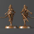 Two Golden Female Warrior Statues Holding Swords Standing On Pedestals