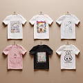 Stylish T-shirts with Various Designs and Colors Hanging on Wall