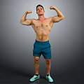 Shirtless Muscular Man Flexing Muscles In Blue Shorts And Green Sneakers Against Gray Background