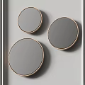 Three Stylish Modern Round Gold Framed Mirrors Hanging On White Wall