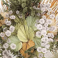 Artistic Natural Decorative Ornaments Arrangement With Green Fan Leaves White Clustered Blooms And Feathery Grass