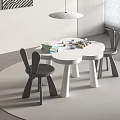 Three Petal Flower Shaped Kids Table With Rabbit Ear Chairs And Building Blocks On Minimalist Rug