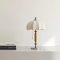Modern Table Lamp With White Lampshade Wooden Stand Silver Base And Stacked Books