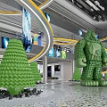 Shopping Mall Lobby With Green Tree Humanoid Sculptures Curved Yellow Lines Screens And Colorful Floor