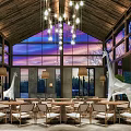 Hotel Lobby With Wooden Ceiling Chandeliers Large Windows And Giraffe Sculptures