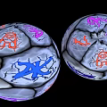Two Wooden Stone Spheres With Cracked Surface And Colorful Orange Purple Blue Patterns