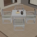 Natural Wood Tea Table and Chairs with Teapot Books on Living Room Rug
