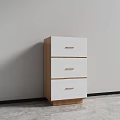 White Three Drawer Cabinet With Wooden Handles And Base Against Gray Wall And Floor