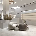 Elegant Modern Boutique Store Interior With Curved Sofa Round Coffee Table And Decorative Plants