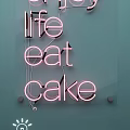 Pink Neon Decorative Lights With Enjoy Life Eat Text On Light Blue Indoor Wall