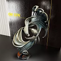 Sleek Metallic Abstract Sculpture With Curved Design And Dark Wooden Backdrop
