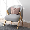 Gray Accent Chair With Wooden Legs And Pink Cushion In Bright Sunlit Room