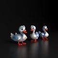 Three Cute White Toy Ducks With Orange Feet On Black Background