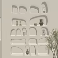 Beige Wall Featuring Irregular Shaped Built In Wall Cabinets With Decorative Items And Potted Plant