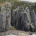 Scenic Coastal Cliff Landscape With Rugged Rock Formations And Green Vegetation