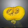 Fresh Sliced Pumpkin With Green Skin Showing Yellow Flesh And Seeds On Gray Surface