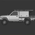 Silver Off Road Pickup Truck With Roof Rack And Orange Cargo On Top