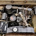 Old Car Engine Bay With Mechanical Parts Pipes And Battery Components