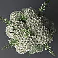 White Hydrangea Flowers In Glass Vase With Polka Dots And Green Leaves