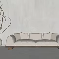 Light Colored Two Seater Sofa With Multiple Pillows Wooden Legs And Twig Decorated Terracotta Pot