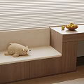 Cozy Indoor Window Bench with Stuffed Bear and Fruit Bowl on Wooden Table