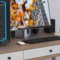Modern Desktop Computer Setup with Monitor Case Keyboard Mouse and Speakers on Wooden Desk