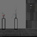 Blue and Red Vases with Flower Branches on Black Pedestals Against White Wall