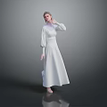 Woman in White Long Dress Standing with Hand Near Face on Grey Reflective Floor Background