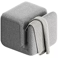 Soft Gray Upholstered Ottoman with Cozy Knitted Blanket in Modern Living Room