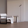 Stylish Minimalist Leisure Chair in Black White with Round Table Floor Lamp and Wooden Floor