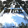 Outdoor Basketball Court With Blue Surface Surrounded By Trees Seating And Fencing