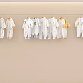 Cute Baby Onesies Hanging Display With White Yellow Blue Colors And Adorable Patterns