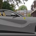 White Ferrari Two Door Sports Car Sleek Design Sharp Headlights Alloy Wheels With Red Accents
