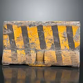 Worn Concrete Traffic Barrier With Yellow And Black Stripes And Textured Surface