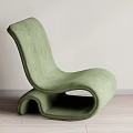 Green Modern Lounge Chair With Unique Curved Shape And Soft Upholstery On Wooden Floor