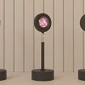 Modern Black Floor Lamp on Round Table with Warm Orange Glow against Vertical Striped Wall