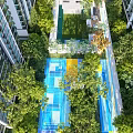 Outdoor Children's Play Area With Colorful Ground Green Trees And Surrounding Buildings