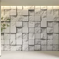 White Textured Stone Wall with Square Blocks and Green Plant in Interior Design