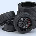 Stacked Black Car Tires with Alloy Rims and Red Brake Calipers