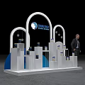 WORLDCOLOUR Art Installation with White Arch Structures Blue Accents Display Stands Cans Person in Suit
