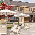 Modern Wooden House Exterior With Outdoor Lounge White Umbrellas And Red Leaf Trees