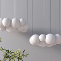 Modern Hanging Chandelier With Multiple White Spherical Balls And Green Plant On Gray Wall