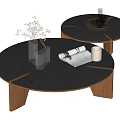 Round Black Wooden Coffee Table with Stacked Design Vase Open Magazine and White Cup