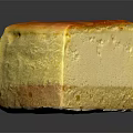 Creamy Cheesecake Slice With Caramelized Top And Crunchy Crust On Black Surface
